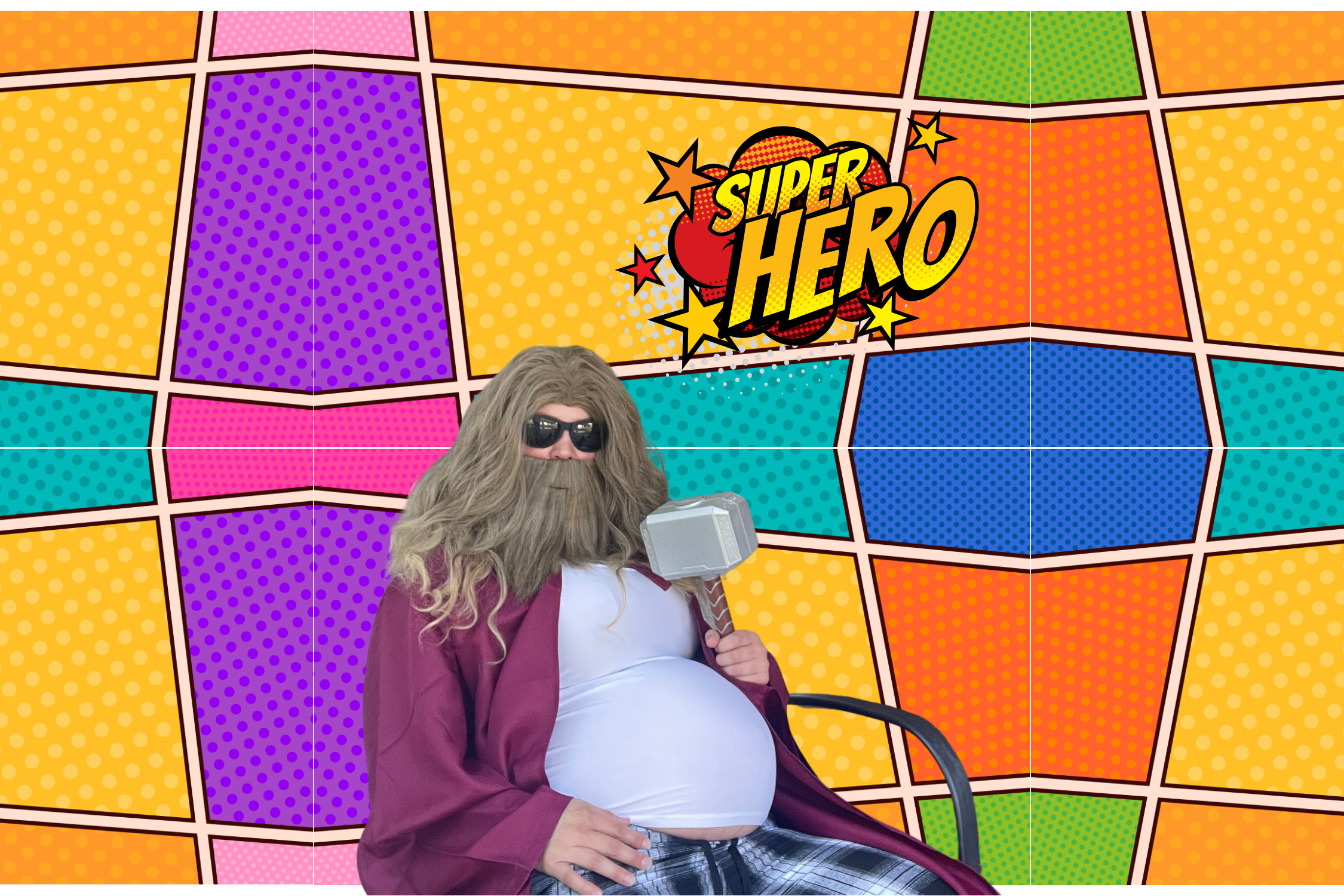 "Guest dressed as Thor in front of superhero-themed photo booth backdrop at Halloween event